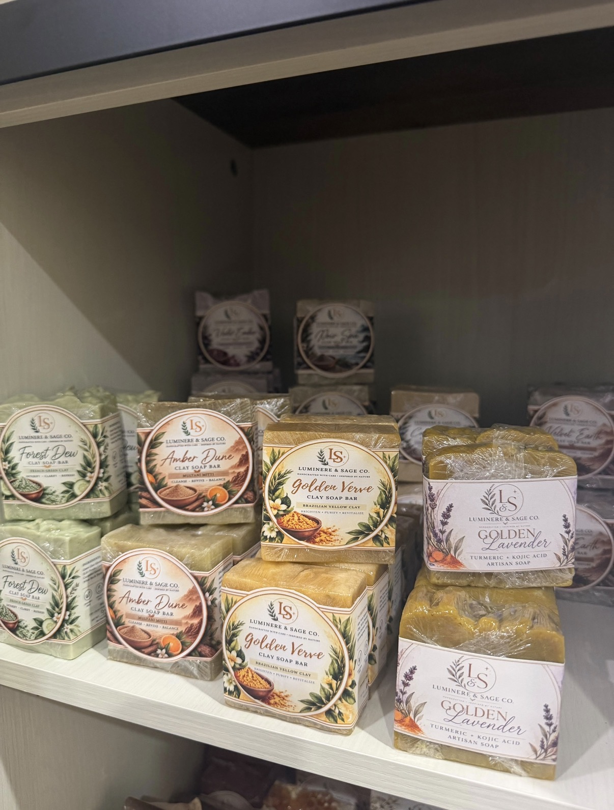 Wrapped soaps with botanical labels neatly displayed on a shelf